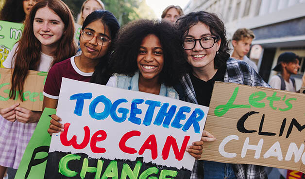 Happy teenage girls joining the global climate strike