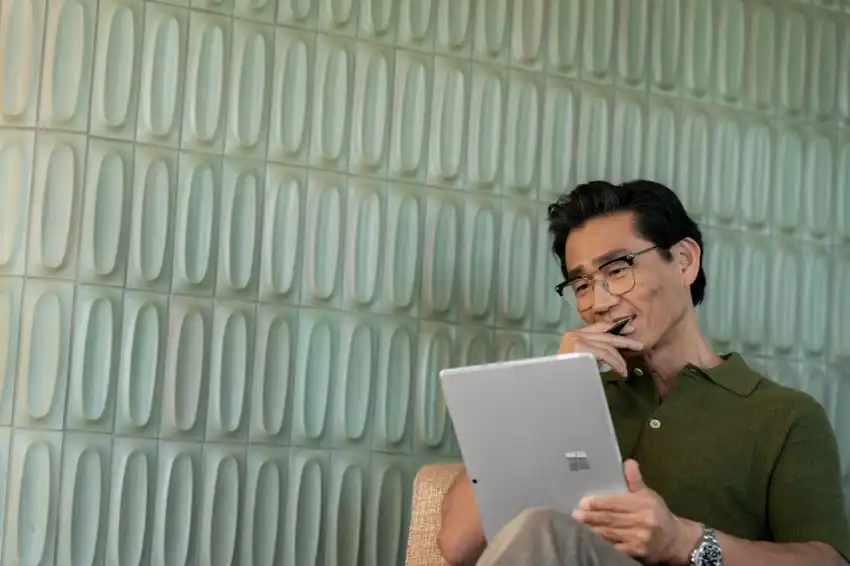 A man looking at a Surface Pro.